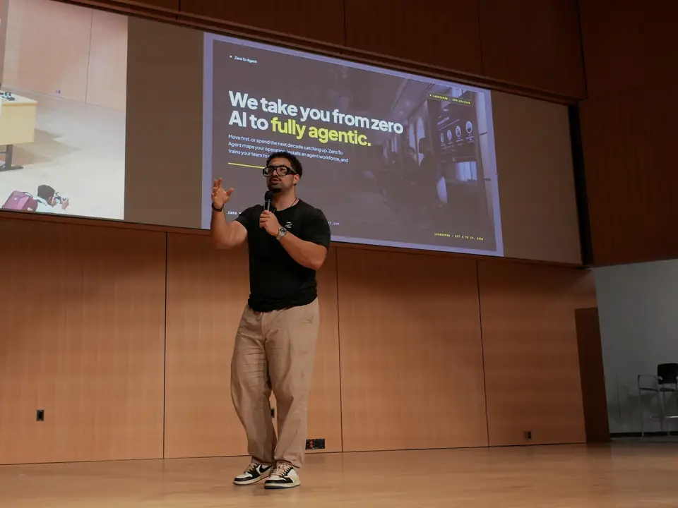 A team member presenting a Zero to Agent slide on a lecture-hall stage in Waterloo.