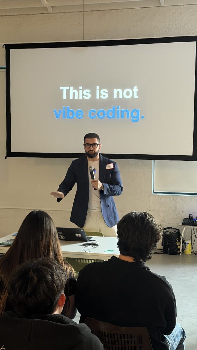 AR Sajid presenting to the room in front of a slide reading This is not vibe coding